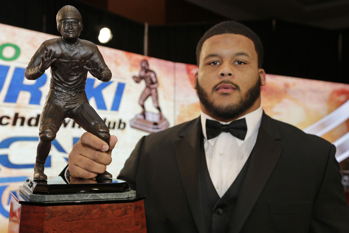Pittsburgh's Aaron Donald poses for a photo with the Bronko Nagurski award for the NCAA college football defensive player of the year during a news conference in Charlotte, N.C., Monday, Dec. 9, 2013. (AP Photo/Chuck Burton)