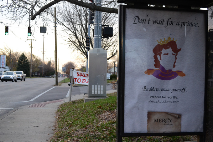 A billboard at a bus stop in Louisville, Ky., on Wednesday, Nov. 20, 2013, shows an ad campaign by Mercy Academy High School. (AP Photo/Dylan Lovan)