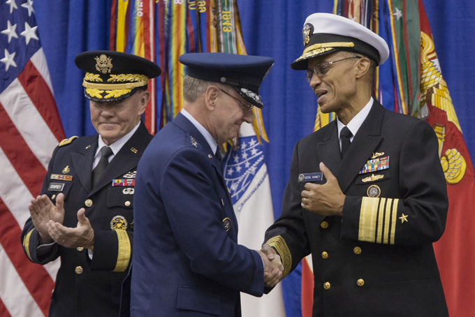 Joint Chiefs Chairman Gen. Martin Dempsey applauds at left as the incoming commander of the US Strategic Command, Adm. Cecil Haney, right, shakes hands with the outgoing commander Gen. C. Robert Kehler during a change-of-command ceremony, Friday, Nov. 15, 2013, at Offutt Air Force Base in Bellevue, Neb. (AP Photo/Nati Harnik)