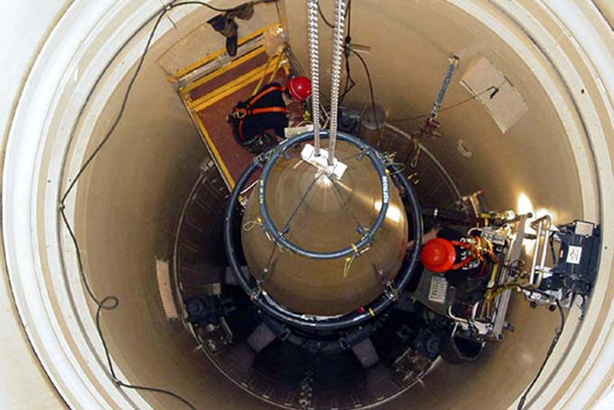In this image released by the U.S. Air Force, a Malmstrom Air Force Base missile maintenance team removes the upper section of an ICBM at a Montana missile site. (AP Photo/U.S. Air Force, John Parie)