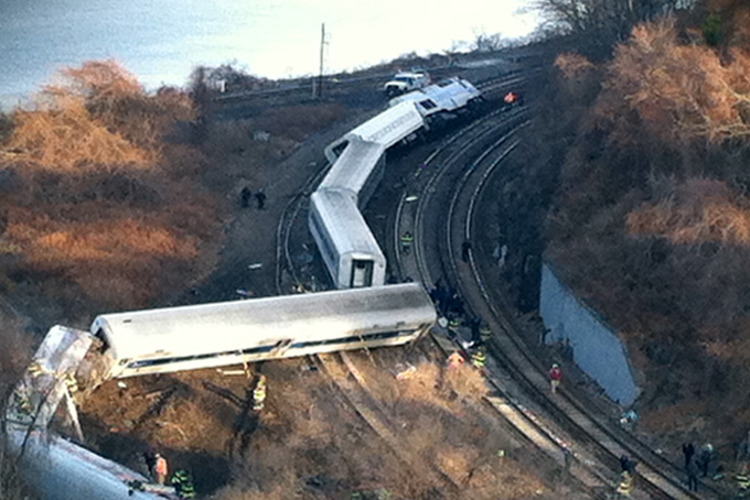 Cars from a Metro-North passenger train are scattered after the train derailed in the Bronx neighborhood of New York, Sunday, Dec. 1, 2013. (AP Photo/Edwin Valero)