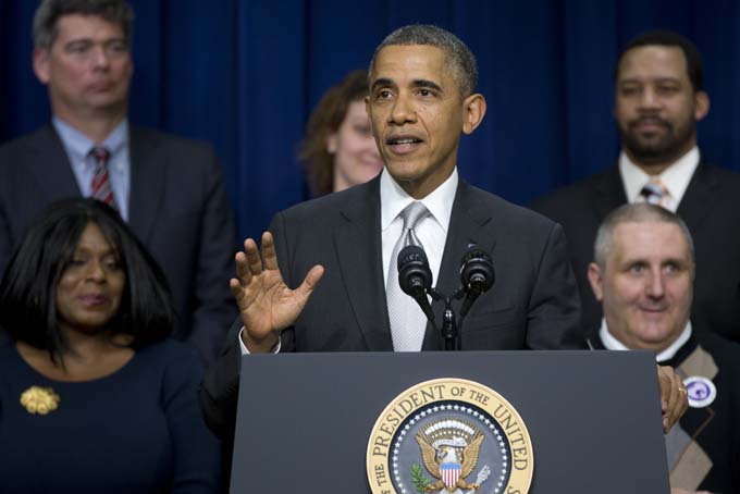 President Barack Obama gestures as he speaks about the new health care law, Tuesday, Dec. 3, 2013, in the South Court Auditorium in the Eisenhower Executive Office Building on the White House complex in Washington. The president said his signature health care law "is working and will work into the future." (AP Photo/Carolyn Kaster)