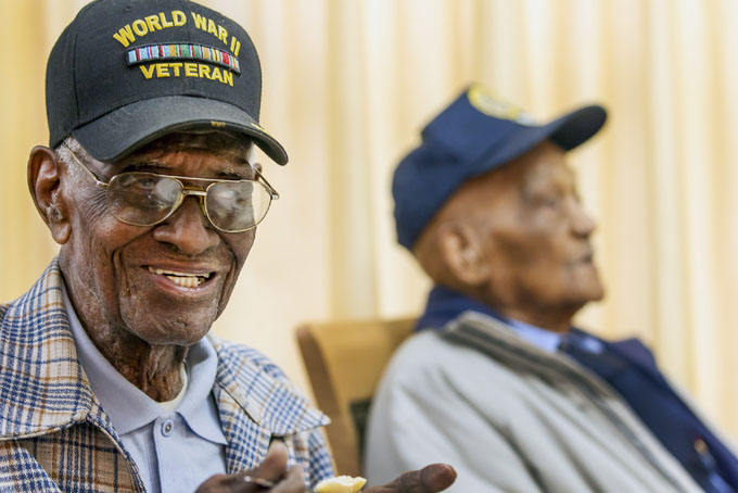 Richard Overton, 107, left, smiles as he finishes his meal at the Emeritus at Parmer Woods on Friday, Dec. 13, 2013, in Austin, Texas. (AP Photo/Austin American-Statesman, Ricardo Brazziell) 