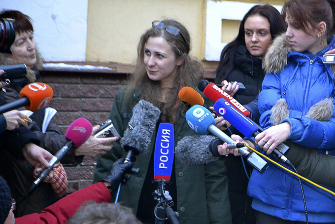 Maria Alekhina, second from left, a member of the Russian punk band Pussy Riot peaks to the media at the Committee against Torture after being released from prison, in Nizhny Novgorod, on Monday, Dec. 23, 2013. (AP Photo/The Committee against Torture) 