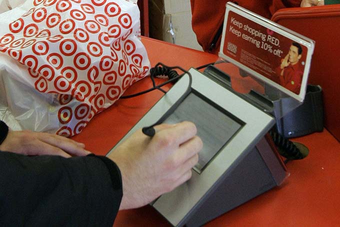 In this Jan. 18, 2008 file photo, a customer signs his credit card receipt at a Target store in Tallahassee, Fla. (AP Photo/Phil Coale, File)