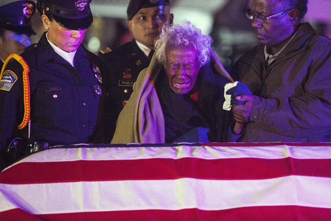  Clara Gantt, the 94-year-old widow of U.S. Army Sgt. Joseph Gantt, weeps in front of her her husband's casket after it was lowered from the plane, Friday, Dec. 20, 2013 in Los Angeles.(AP Photo/Los Angeles Times, Andrew Renneisen, Pool)