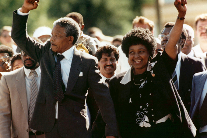 In this Feb. 11, 1990 file photo, Nelson Mandela, left, and his wife, Winnie, walk out of the Victor Verster prison in Paarl, near Cape Town, South Africa, after Mandela had spent 27 years in jail. South Africa's President Jacob Zuma said, Thursday, Dec. 5, 2013, that Mandela has died. He was 95. (AP Photo/Greg English, File)