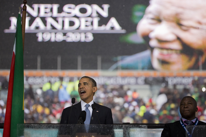 President Barack Obama speaks to crowds attending the memorial service for former South African president Nelson Mandela at the FNB Stadium in Soweto near Johannesburg, Tuesday, Dec. 10, 2013. (AP Photo/Evan Vucci)