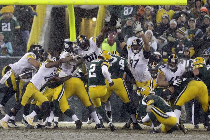 Green Bay Packers' Mason Crosby has a field goal attempt blocks during the second half of an NFL football game against the Pittsburgh Steelers Sunday, Dec. 22, 2013, in Green Bay, Wis. The Steelers were called for a batting penalty on the play. (AP Photo/Mike Roemer)