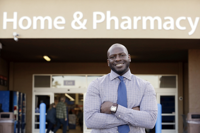 This photo taken Nov. 21, 2013 shows James Lott outside the Wal-Mart store where he works as a pharmacist in Bonney Lake, Wash. Lott, who lives in Renton, Wash., a suburb of Seattle, adds significantly to his six-figure job salary by day-trading stocks. It's not just the wealthiest 1 percent: Fully 20 percent of U.S. adults become rich for parts of their lives, wielding outsized influence on America's economy and politics. And this little-known group may pose the biggest barrier to reducing the nation's income inequality. While the growing numbers of the U.S. poor have been well documented, survey data provided exclusively to The Associated Press detail the flip side of the record income gap: the rise of the "new rich." (AP Photo/Elaine Thompson)