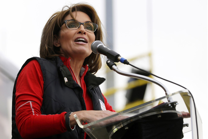 This Oct. 12, 2013 file photo shows former Alaska Gov. Sarah Palin during a rally supporting Steve Lonegan who was running for the vacant New Jersey seat in the U.S. Senate, in New Egypt, N.J. The Sportsman Channel said Monday it has hired Sarah Palin to be host of a weekly outdoors-oriented program that will celebrate the "red, wild and blue" lifestyle. The program, "Amazing America," will debut next April. (AP Photo/Julio Cortez, File)