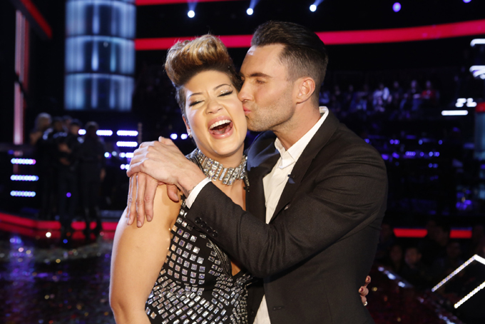 In this photo provided by NBC, Maroon 5 frontman Adam Levine, right, kisses Tessanne Chin on the cheek after Chin was announced the season five winner of “The Voice” on Dec. 17, 2013, in Los Angeles. (AP Photo/NBC,Trae Patton)