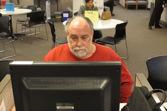 Richard Mattos, 59, looks for jobs at a state-run employment center in Salem, Ore., on Thursday, Dec. 26, 2013. Mattos is one of more than 1 million Americans who will lose federal unemployment benefits at year's end. (AP Photo/Jonathan J. Cooper