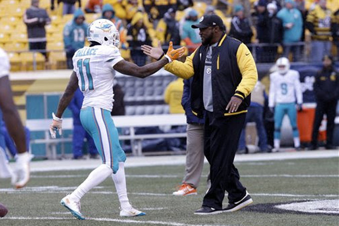 Miami Dolphins wide receiver Mike Wallace (11) shakes hands with Pittsburgh Steelers head coach Mike Tomlin before an NFL football game in Pittsburgh, Sunday, Dec. 8, 2013. Miami won 34-28. (AP Photo/Tom E. Puskar)