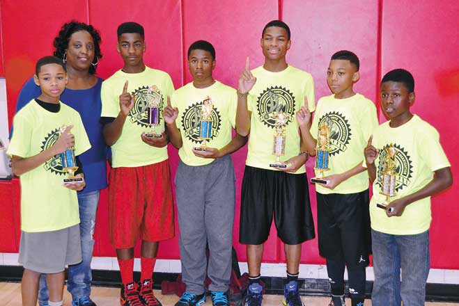 Winners—Top dogs of the three-on-three tournament with Beverly Durrett, executive director of the Kenny Durrett Youth Organization.