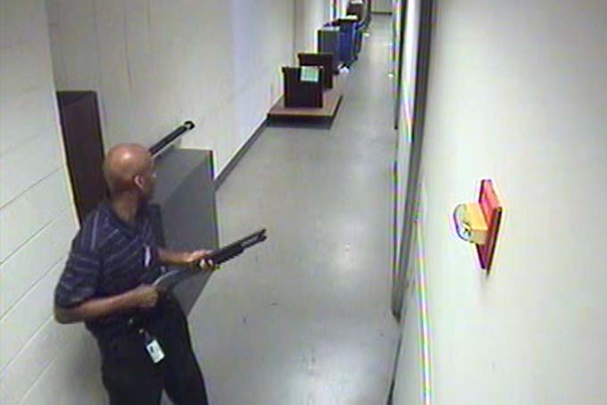 In this Monday, Sept. 16, 2013 image from video provided by the FBI, Aaron Alexis holds a shotgun as he moves through the hallways of Building #197 at the Washington Navy Yard in Washington. Alexis, a 34-year-old former Navy reservist and IT contractor, shot and killed 12 people inside a Navy Yard building last week before being killed in a shootout with police. (AP Photo/FBI)