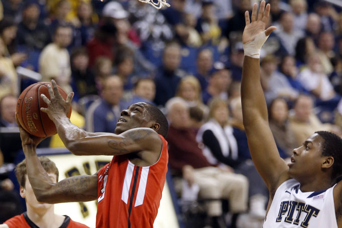 Pitt's Josh Newkirk (13) defends as Youngstown State's Kendrick Perry shoots during the second half of an NCAA college basketball game on Saturday, Dec. 14, 2013, in Pittsburgh. (AP Photo/Keith Srakocic)
