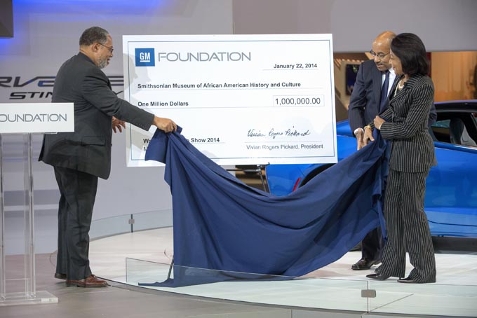General Motors Foundation President Vivian Pickard (right) and GM Vice President Global Design Ed Welburn (right center) unveil the GM Foundation’s $1 million grant for the creation of the Smithsonian Museum of African American History and Culture with Founding Director of the Smithsonian Museum of African American History and Culture Lonnie Bunch Wednesday, January 22, 2014 at the Washington Auto Show in Washington, DC. The grant will support the design and installation of the Museum’s permanent exhibitions. (Photo by Mark Finkenstaedt for General Motors) 