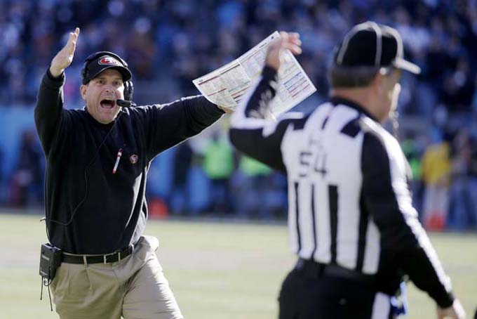 San Francisco 49ers head coach Jim Harbaugh reacts to a a call at the end of the first half against the Carolina Panthers during the first half of a divisional playoff NFL football game, Sunday, Jan. 12, 2014, in Charlotte, N.C. (AP Photo/John Bazemore)