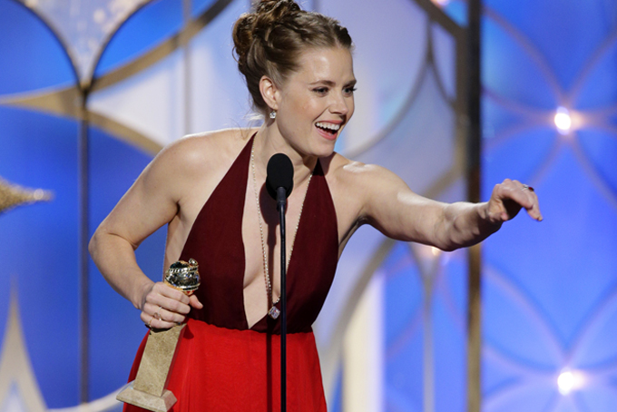 This image released by NBC shows Amy Adams accepting the award for best actress in a motion picture, musical or comedy for her role in, "American Hustle"  during the 71st annual Golden Globe Awards at the Beverly Hilton Hotel on Sunday, Jan. 12, 2014, in Beverly Hills, Calif. (AP Photo/NBC, Paul Drinkwater)