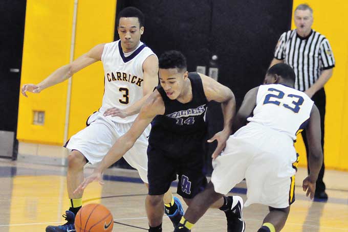 ALEN HORD (14) of USO goes for a loose ball between Carrick's Cameron Jackson (3) and Taylor Thornton (23), Hord scored 16 points in USO's 82-55 win