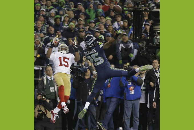 Seattle Seahawks' Richard Sherman tips a pass intended for San Francisco 49ers' Michael Crabtree (15) in the final seconds of the second half of the NFL football NFC Championship game Sunday, Jan. 19, 2014, in Seattle. Malcolm Smith intercepted the tipped pass. The Seahawks won 23-17 to advance to Super Bowl XLVIII. (AP Photo/Marcio Jose Sanchez, File)
