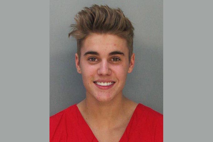  This police booking mug made available by the Miami Dade County Corrections Department shows pop star Justin Bieber, Thursday, Jan. 23, 2014. (AP Photo/Miami Dade County Jail)