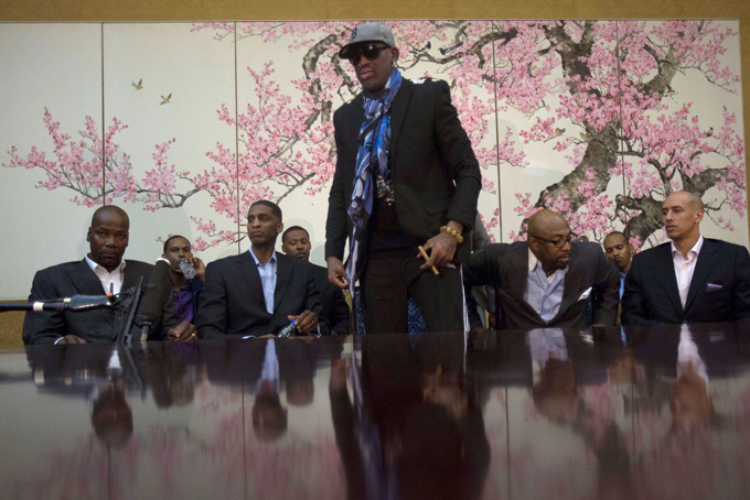 Dennis Rodman stands up to leave after he and fellow US basketball players completed a television interview at a Pyongyang, North Korea hotel Tuesday, Jan. 7, 2014. Rodman came to the North Korean capital with a team of USA basketball stars for an exhibition game on Jan. 8, the birthday of North Korean leader Kim Jong Un. From left to right are Cliff Robinson, Jerry Dupree, Charles D. Smith, unidentified, Vin Baker, Andre "Silk" Poole and Doug Christie. (AP Photo/David Guttenfelder)AP Video.