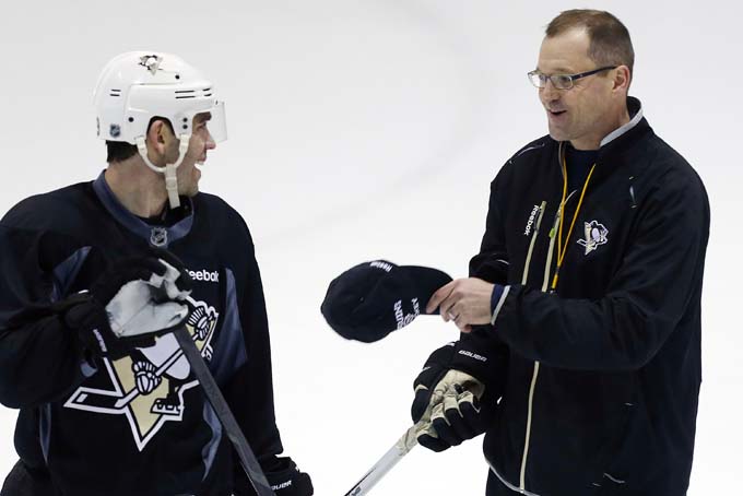 In this Jan. 13, 2013 file photo, Pittsburgh Penguins head coach Dan Bylsma, right, talks with' Pascal Dupuis during NHL hockey practice in Canonsburg, Pa. The affable Penguins coach will try to lead Team USA to its first gold in 32 years next month at the Winter Olympics in Sochi. (AP Photo/Gene J. Puskar, File)