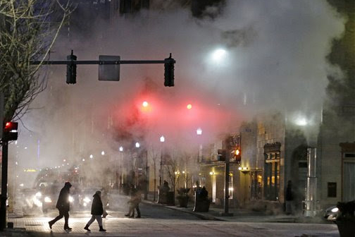With temperatures nearing zero a cloud of steam from a manhole blows across an intersection in downtown Pittsburgh during evening the evening rush hour Monday, Jan. 6, 2014. The National Weather service is calling for a temperature of -11 degrees overnight, with a high of 2 degrees on Tuesday.(AP Photo/Gene J. Puskar)