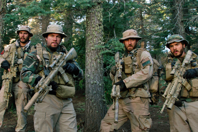 This photo released by Universal Pictures shows, from left, Taylor Kitsch, as Michael Murphy, Mark Wahlberg as Marcus Luttrell, Ben Foster as Matt “Axe” Axelson, and Emile Hirsch as Danny Dietz in a scene from the film, “Lone Survivor." In the age of the superhero, the movies' most reliable real-life hero has been the Navy SEAL. "Lone Survivor," is the latest in a string of films, including "Zero Dark Thirty" and "Act of Valor" to honor the Navy's special operations force with as much faithfulness as the filmmakers could muster. (AP Photo/Universal Pictures)