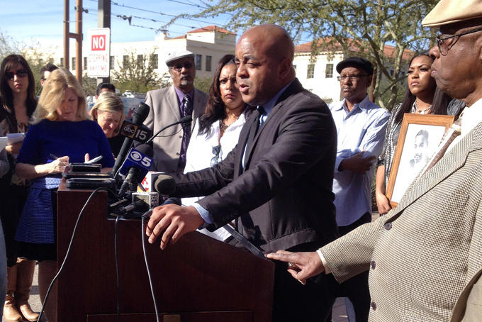 The Rev. Jarrett Maupin, center, an Arizona civil rights activist, speaks during a news conference in Phoenix, Tuesday, Jan. 21, 2014, after an Arizona State University fraternity hosted a distasteful party in commemoration of Martin Luther King Jr. Day, replete with racist stereotypes and offensive costumes. Maupin is calling on the school to expel all students involved and permanently ban the Tau Kappa Epsilon fraternity from campus. (AP Photo/Brian Skoloff)