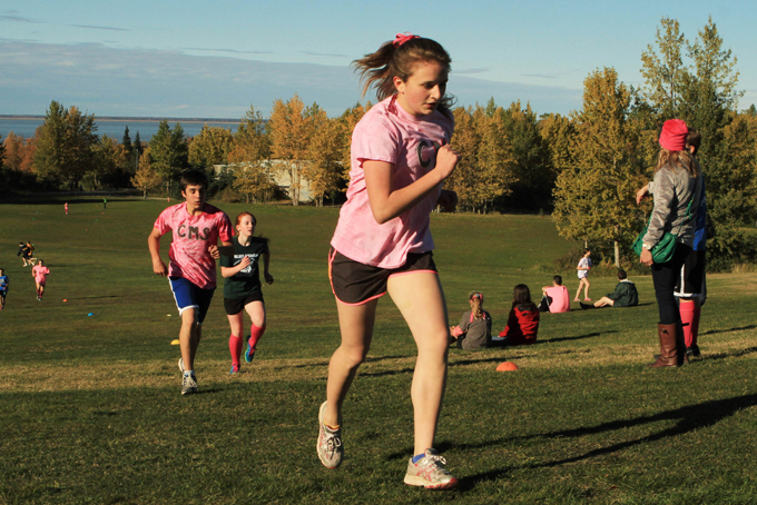 Central and Mirror Lake Middle School cross-country runners, wearing pink for breast cancer awareness, climb the final hill of a cross-country race at Kincaid Park in Anchorage, Alaska on Tuesday, Oct. 1, 2013. According to the Centers for Disease Control and Prevention, only 1 in 4 U.S. kids aged 12 to 15 meet the recommendations of an hour or more of moderate to vigorous activity every day. The CDC released partial results Wednesday, Jan. 8, 2014 from a fitness survey, which involved kids aged 3 to 15. (AP Photo/Dan Joling)
