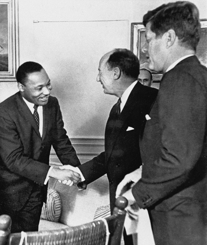 In this Dec. 17, 1962 file photo, Ambassador Adlai Stevenson, the U.S. delegate to the United Nations, shakes hands with Martin Luther King Jr., president of the Southern Christian Leadership Conference, Atlanta, Ga., at the White House in Washington with President John F. Kennedy at right. (AP Photo, File)
