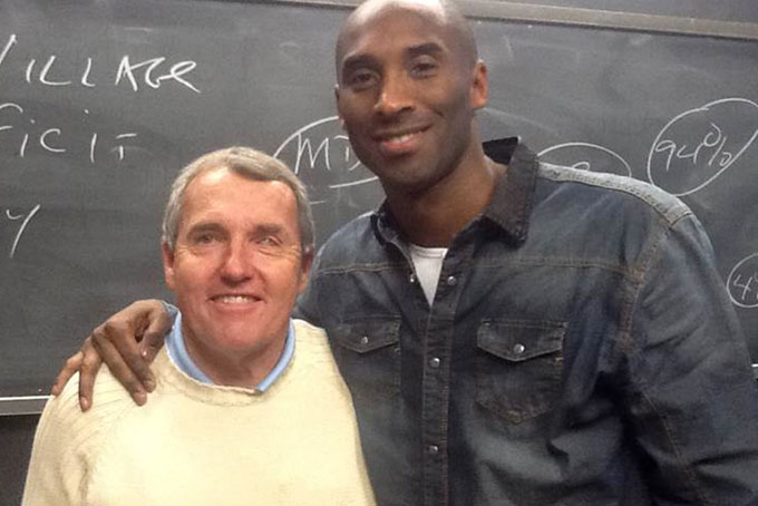 In a photo taken by a student and provided by Boston College, Boston College professor Nick Nugent and Los Angeles Lakers' Kobe Bryant pose for a photo Thursday, Jan. 16, 2014, at Nugent's international marketing class at Boston College in Chestnut Hill, Mass. (AP Photo/Student photo via Boston College)