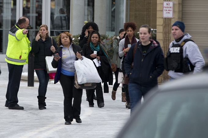 Police and law enforcement evacuate the Mall of Columbia after a shooting on Saturday, Jan. 25, 2014 in Columbia, Md. (AP Photo/ Evan Vucci)