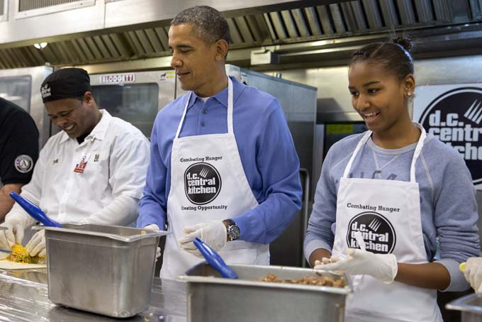 President Barack Obama and his daughter Sasha, right, make burritos at DC Central Kitchen as part of a service project in honor of Martin Luther King, Jr. Day, Monday, Jan. 20, 2014, in Washington. Also helping were first lady Michelle Obama and daughter Malia Obama. (AP Photo/Jacquelyn Martin)