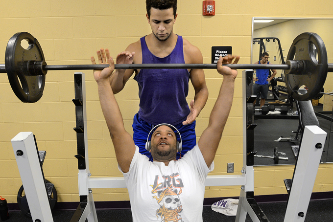Walter Jones lifts weights as his cousin, Rico Jones, spots for him Monday, Dec. 30, 2013, at the Grant County Family YMCA in Marion, Ind. The cousins say they resolve to keep fit in the new year. AP Photo/Chronicle-Tribune, Jeff Morehead)