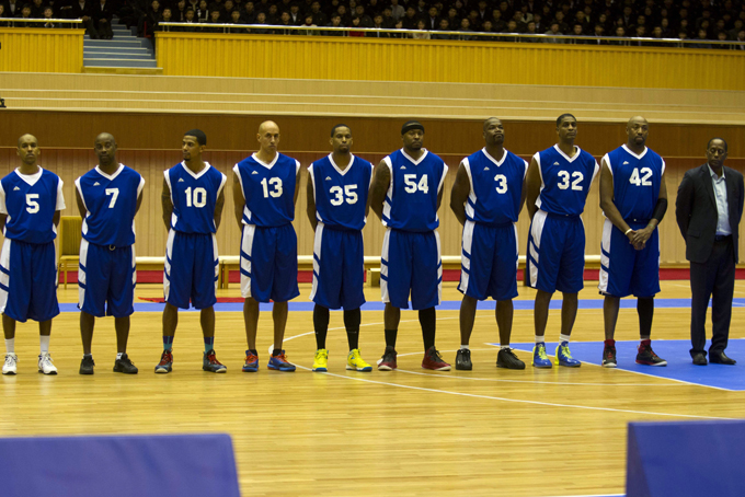 U.S. basketball players line up before an exhibition basketball game at an indoor stadium in Pyongyang, North Korea on Wednesday, Jan. 8, 2014. From left to right are Andre "Silk" Poole, Kenny Anderson, Guy Dupree, Doug Christie, Jerry Dupree, Antoinne Scott, Cliff Robinson, Charles D. Smith and Vin Baker. (AP Photo/Kim Kwang Hyon)