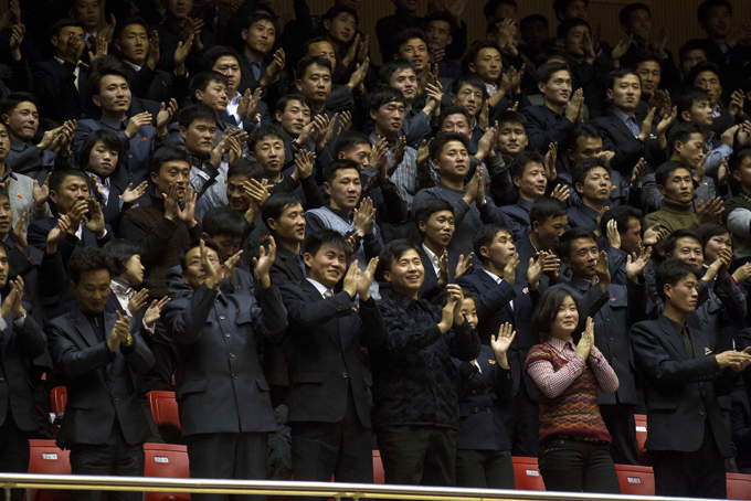 North Koreans cheer during an exhibition basketball game between U.S. and North Korean players at an indoor stadium in Pyongyang, North Korea on Wednesday, Jan. 8, 2014. (AP Photo/Kim Kwang Hyon)