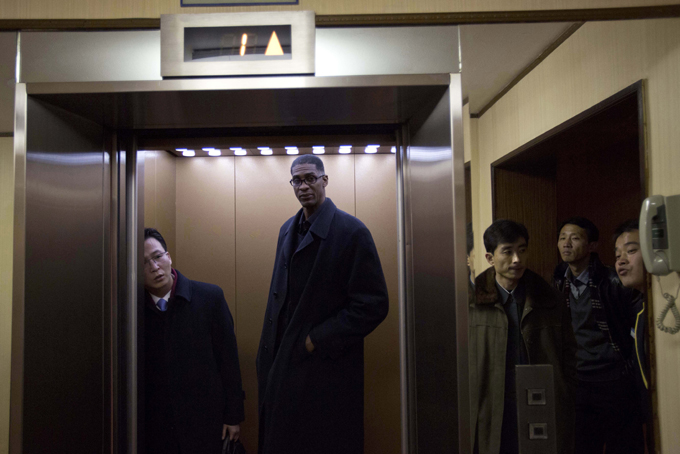 Former Pitt and NBA basketball star Charles D. Smith enters an elevator at a hotel in Pyongyang, North Korea on Monday, Jan. 6, 2014. (AP Photo/David Guttenfelder)