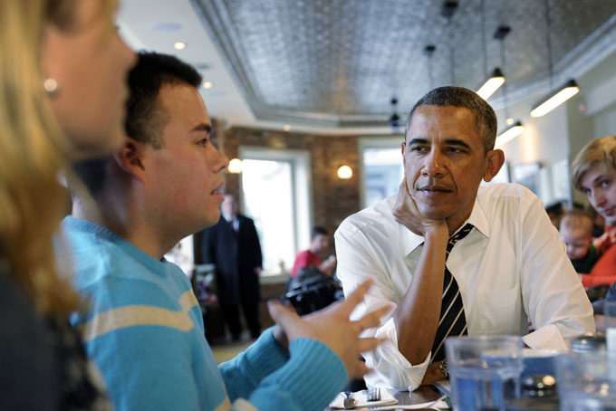 Caption President Barack Obama listens to Andres Cruz, second from left, as he has lunch with five young people at The Coupe restaurant in the Columbia Heights section of Washington, Friday, Jan. 10, 2014. The five are spearheading creative outreach efforts to connect with and help enroll young consumers through the Marketplaces or are interested in getting more involved with these efforts. Seated at the table with Obama at left is Anne Johnson. (AP Photo/Susan Walsh)