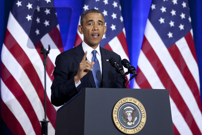 President Barack Obama gestures as he speaks about National Security Agency (NSA) surveillance, Friday, Jan. 17, 2014, at the Justice Department in Washington. The president called for ending the government's control of phone data from millions of Americans. (AP Photo/Carolyn Kaster)