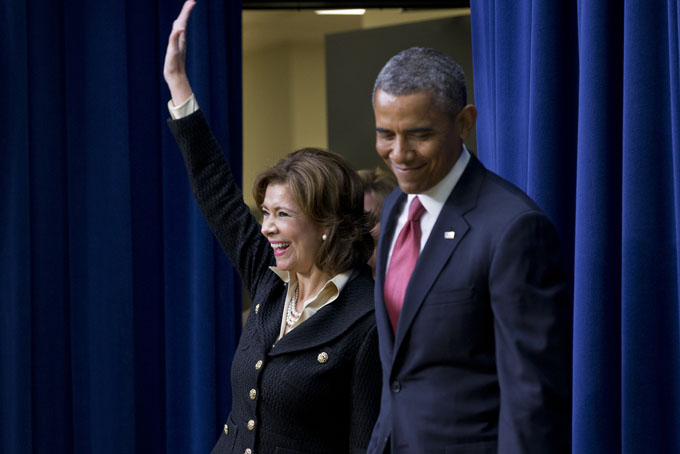 Maria Contreras-Sweet, founder and board chairman of a Latino-owned community bank in Los Angeles, accompanied by President Barack Obama, waves as they enter the South Court Auditorium of the Eisenhower Executive Office Building on the White House complex in Washington, Wednesday, Jan. 15, 2014, where the president announced he would nominate Contreras-Sweet to head the Small Business Administration (SBA) . (AP Photo/Jacquelyn Martin)