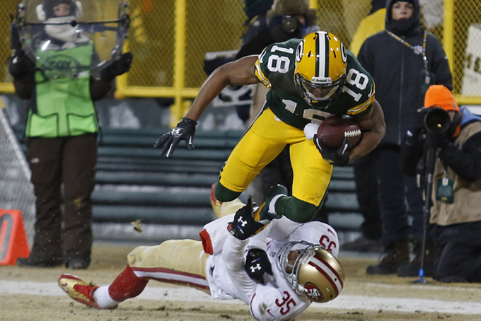 Green Bay Packers wide receiver Randall Cobb is hit after making a catch by San Francisco 49ers free safety Eric Reid during an NFL wild-card playoff football game Sunday, Jan. 5, 2014, in Green Bay, Wis. (AP Photo/Matt Ludtke)