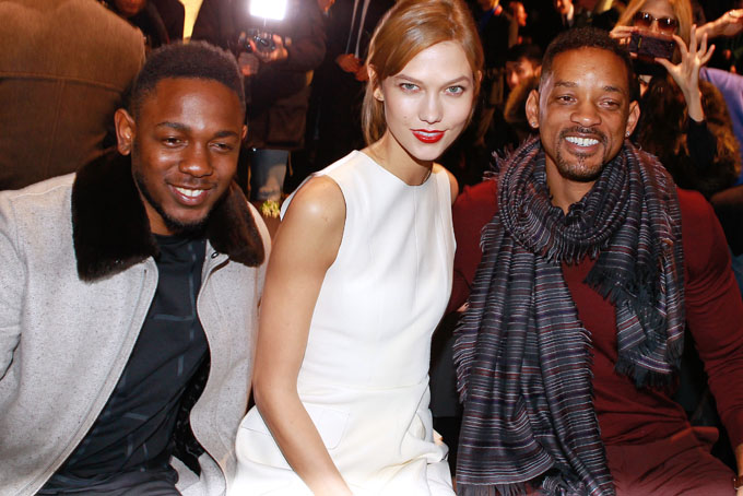 From left, rap singer Kendrick Lamar, model Karlie Kloss and actor Will Smith attend the Dior men's Fall-Winter 2014-2015 fashion collection, presented Saturday, Jan. 18, 2014 in Paris. (AP Photo/Jacques Brinon)