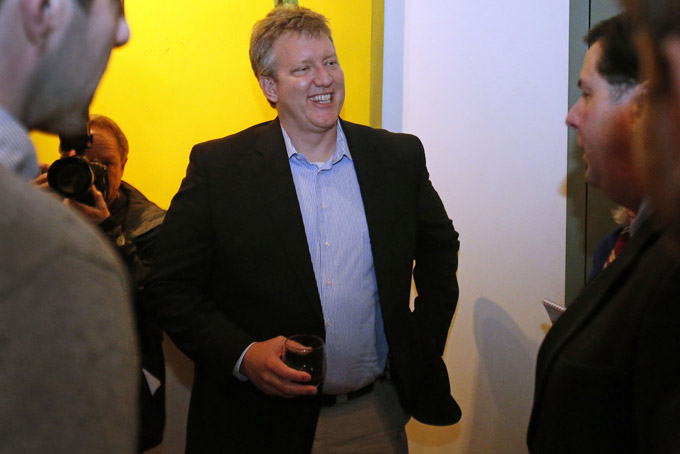 Hollywood producer Chris Moore, center, talks with Pittsburgh Mayor Bill Peduto, right, during a reception Monday, Jan. 13, 2014, in Pittsburgh. Moore, known for the films "Good Will Hunting" and "Promised Land," is producing a Pittsburgh-based reality TV series, "The Chair." The show will chronicle the efforts of two young directors as they make separate movies from the same script. (AP Photo/Gene J. Puskar)