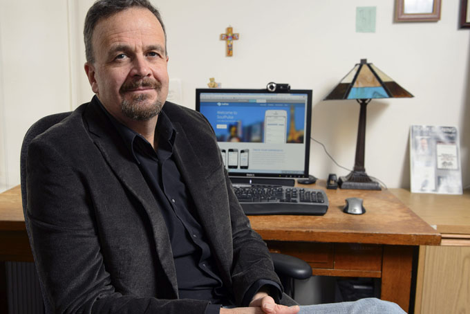 In this Dec. 20, 2013 photo, Bradley Wright, associate professor of sociology, poses in his office at the University of Connecticut in Storrs, Conn. (AP Photo/University of Connecticut, Peter Morenus)