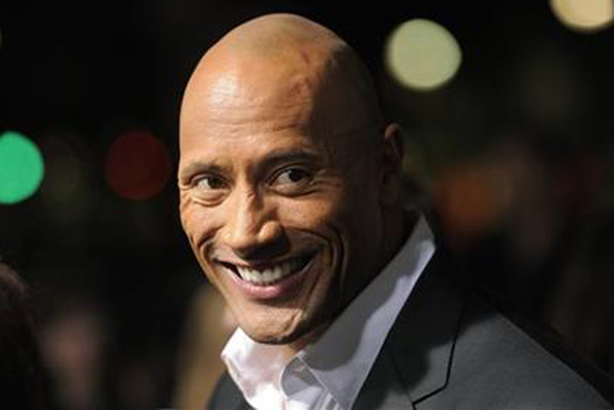 This March 28, 2013 file photo shows Dwayne Johnson, a cast member in "G.I. Joe: Retaliation," at the Los Angeles premiere in Los Angeles. Johnson also hosts "The Hero," competition series on TNT. The season finale airs Thursday, Aug. 1. (Photo by Chris Pizzello/Invision/AP, File)