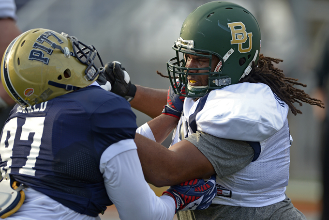 North Squad defensive tackle Aaron Donald of Pittsburgh (97), left, drills against offensive guard Cyril Richardson of Baylor (68) during Senior Bowl practice at Ladd-Peebles Stadium, Monday, Jan. 20, 2014, in Mobile, Ala. (AP Photo/G.M. Andrews)